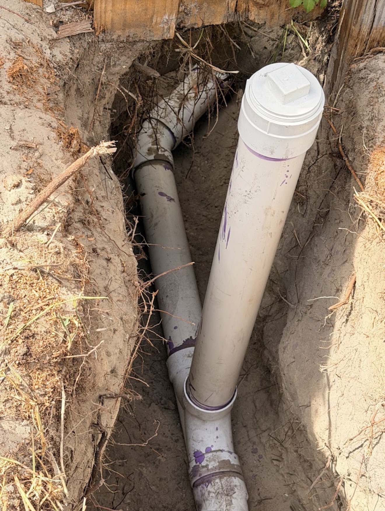 PVC sewer pipe repair and cleanout installation